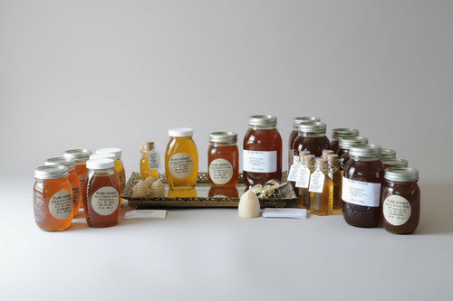 Jars of honey with labels on a white surface