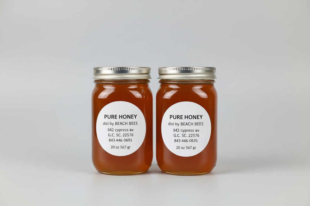 Two jars of pure honey with labels