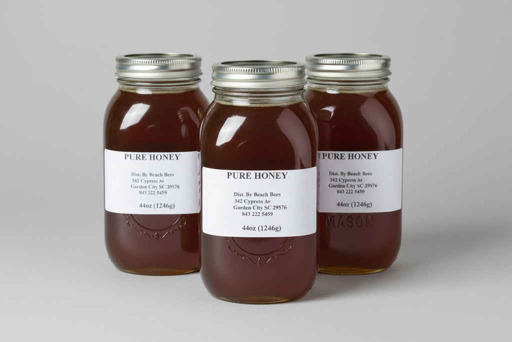 Three jars of pure honey with labels 